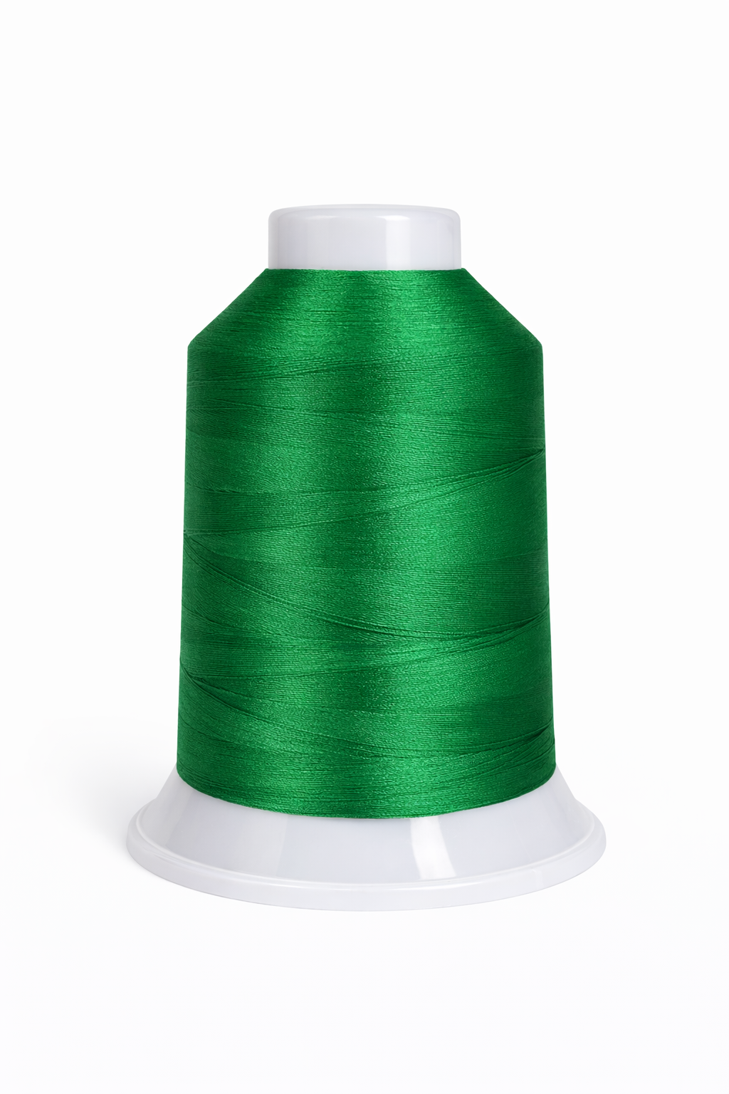 Green spool of thread on a white background