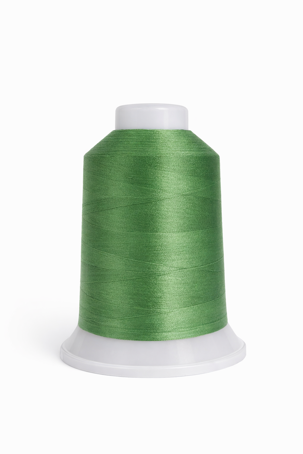 Spool of green thread on a white background