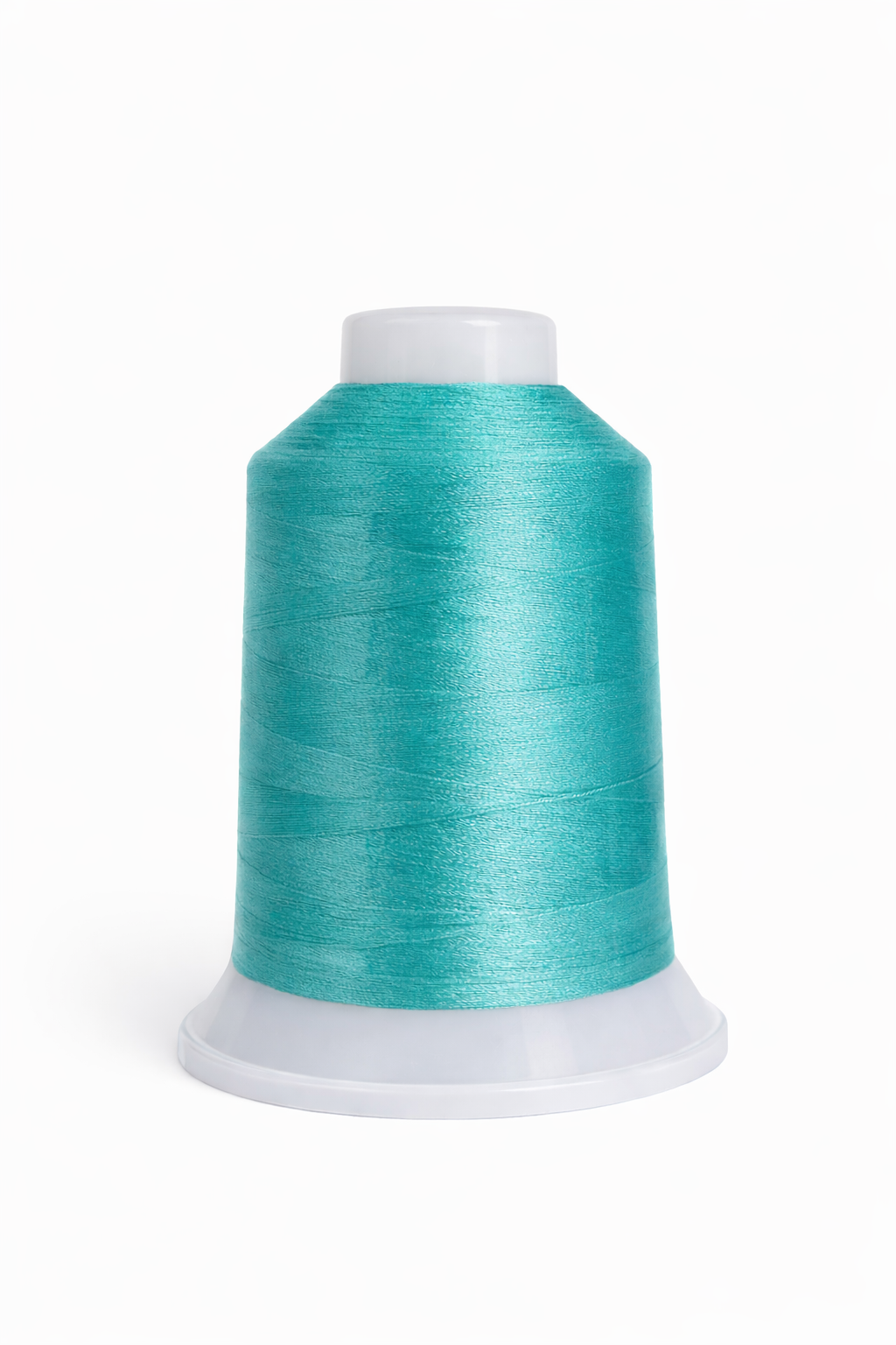 Turquoise spool of thread on a white background