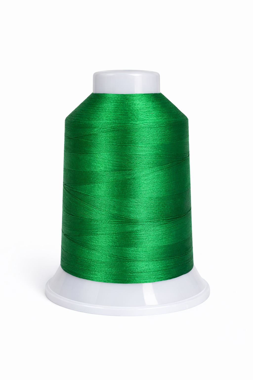 Spool of green thread on a white background